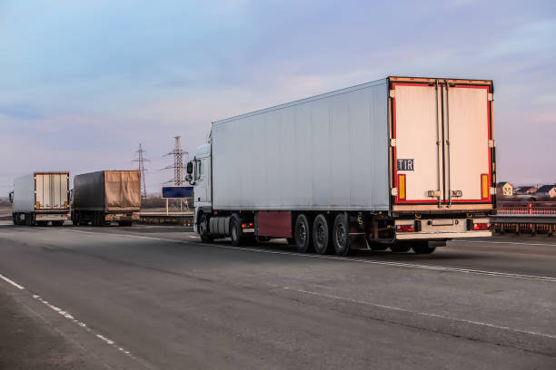 istock Trucks moving on a suburban highway 1292603321