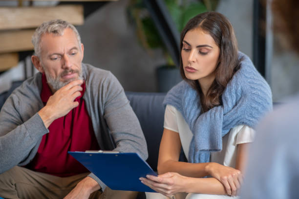 istock Man and woman checking their therapist report 1292605886