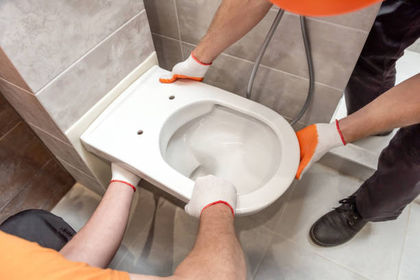 istock Workers are installing a wall-hung toilet on the wall. 1292606067