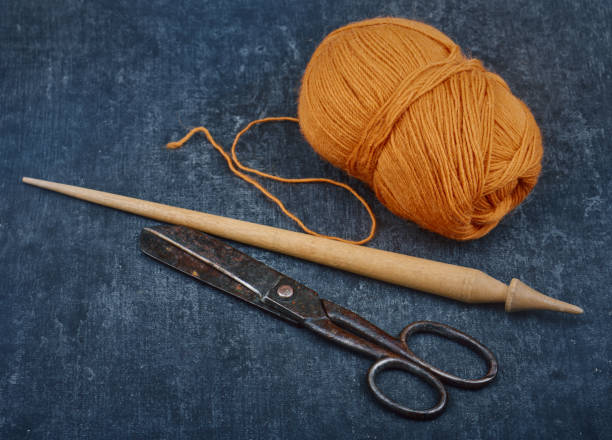 istock Old used tailoring tools and a skein of woolen thread, shallow depth of sharpness 1292608172