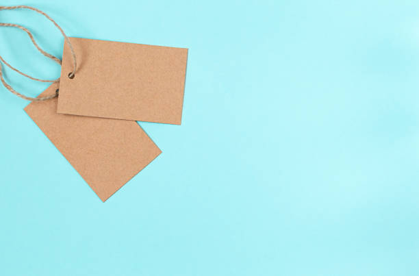 istock Blank old paper cloth tag or label on blue background 1292608555