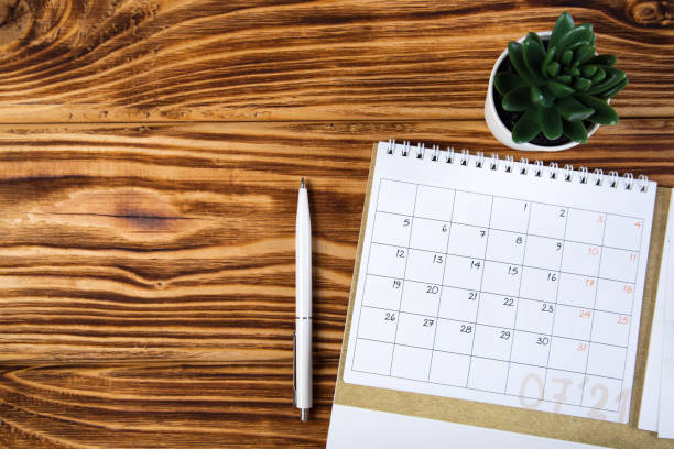 istock white calendar for 2021 month schedule to make an appointment or manage the schedule every day on a wooden table with succulent and ballpoint pen for marks, for work planning 1292613086