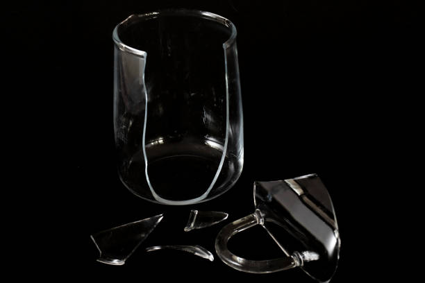 istock crushed glass cup, fragments scattered, isolated on black background. 1292613643