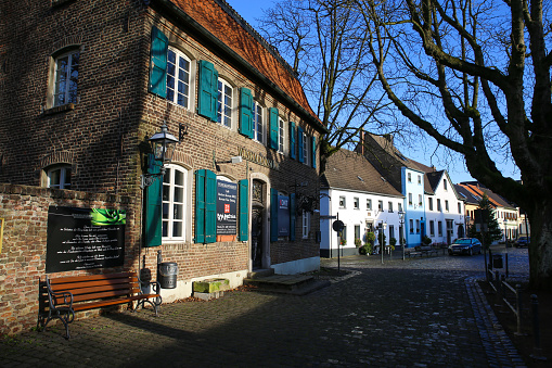 People shopping in the streets of Zwolle during the annual Blauwvingerdagen market fair held every year on wednesdays in July. People are looking at the market stalls and enjoying food and drinks at the outdoor bar seatings.