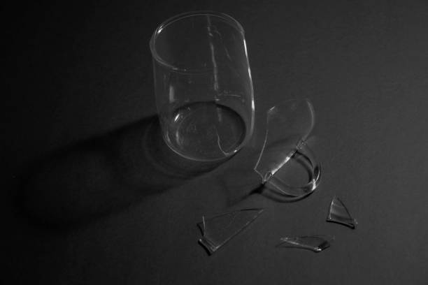 istock crushed glass cup, fragments scattered, isolated on black background. 1292614056