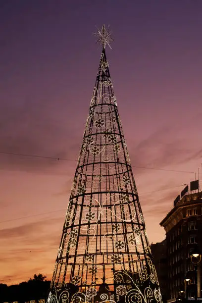 Modern lights Christmas tree, townsquare in A Coruña, Galicia, Spain. Sunset background.