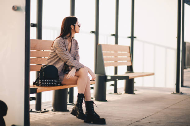 istock Young woman is waiting in a bus stop 1292615255