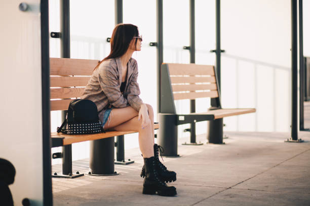 istock Young woman is waiting in a bus stop 1292615256
