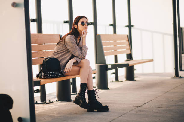 istock Young woman is waiting in a bus stop 1292615305