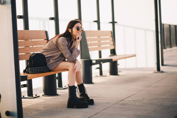 istock Young woman is waiting in a bus stop 1292615314