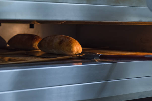 istock Ciabatta bread in an industrial oven. Making craft bread at the bakery 1292615333