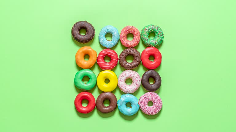 Chocolate donuts top view stop motion. Eating glazed doughnuts