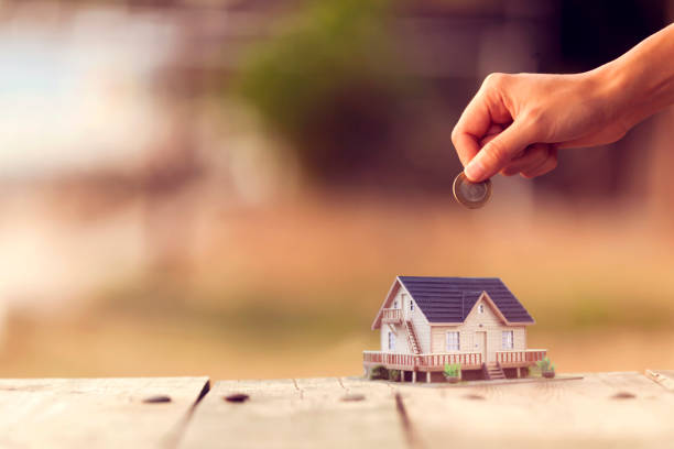 istock Real Estate Agent with house model and saving concepts 1292616286
