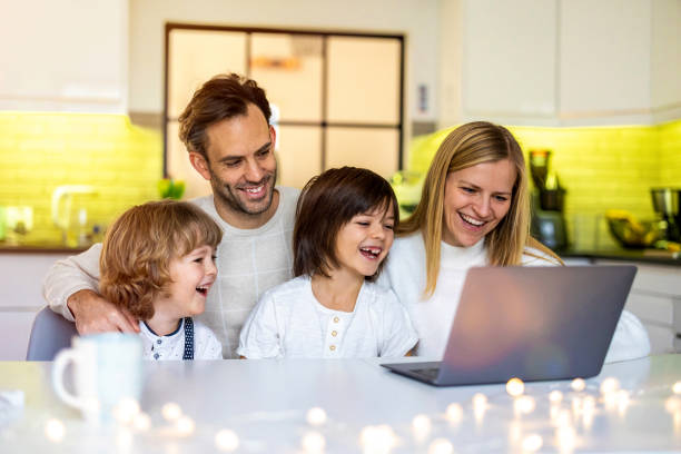 istock Happy young family using laptop at home 1292616536