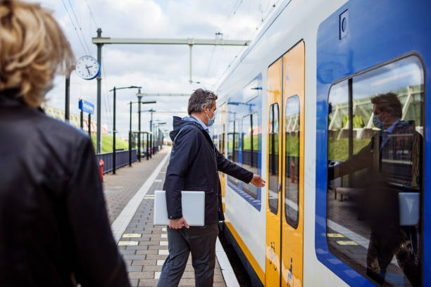 istock Corona practices for a commuter train traveller business couple 1292617110
