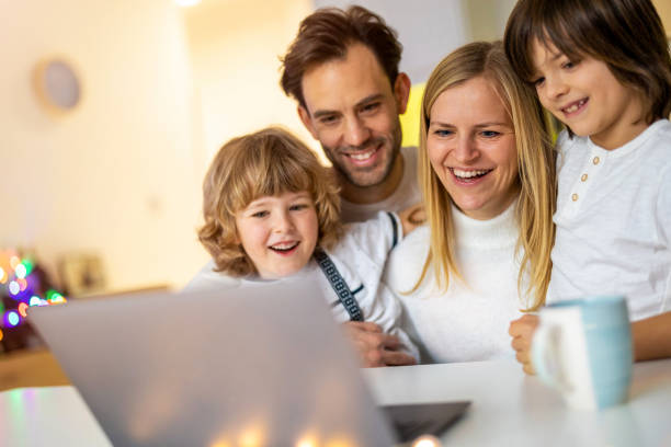 istock Happy young family using laptop at home 1292617146