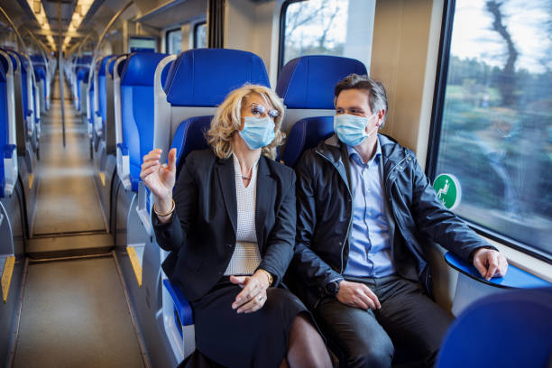 istock Corona practices for a commuter train traveller business couple 1292617314