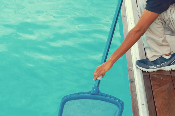 istock Hotel staff worker cleaning the pool 1292617515