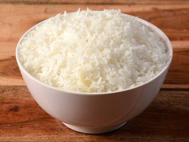 istock Cooked plain white basmati rice served in a bowl over rustic wooden background, selective focus 1292617646