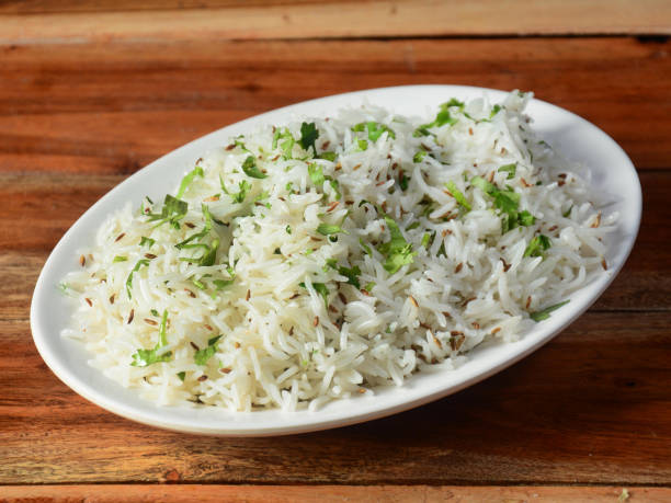istock Cumin rice or Jeera Rice is a popular Indian main course item made using Basmati rice flavored with fried cumin seeds and basic spices, selective focus 1292618300