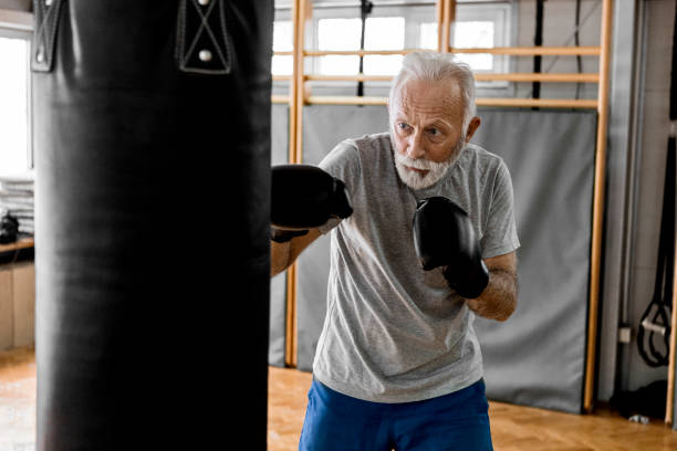 Training boxing Senior in gym training boxing old man boxing stock pictures, royalty-free photos & images
