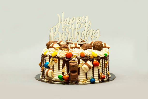 istock Birthday layer cake decorated with chocolate pieces with happy birthday text 1292623142