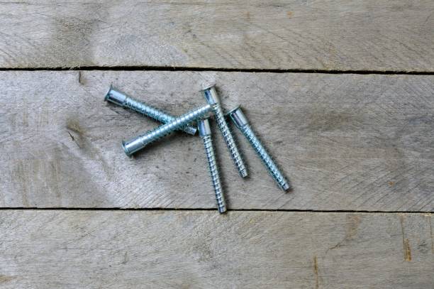 istock five euroscrews on a wooden background. flat lay 1292623149