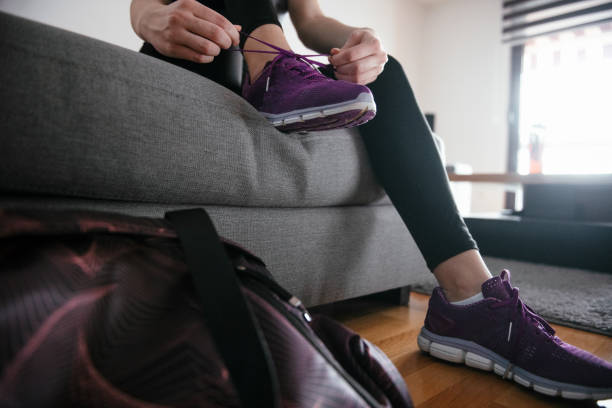 istock Woman tying laces preparing for training 1292623407