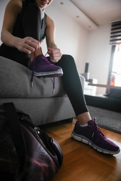 istock Woman tying laces preparing for training 1292623410