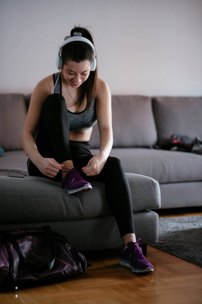 istock Woman tying laces preparing for training 1292623548