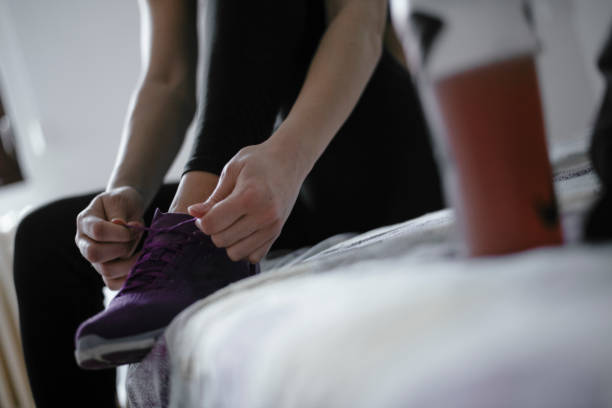 istock Woman tying laces preparing for training 1292624282