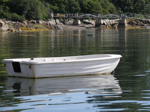 A small dinghy moored in the water off Maine.