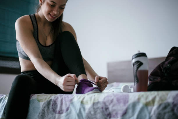 istock Woman tying laces preparing for training 1292624532