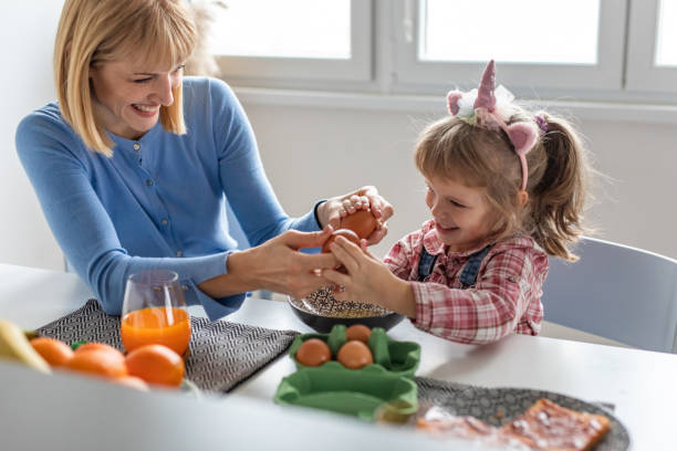 istock Mother and daughter preparing breakfast at home 1292624658