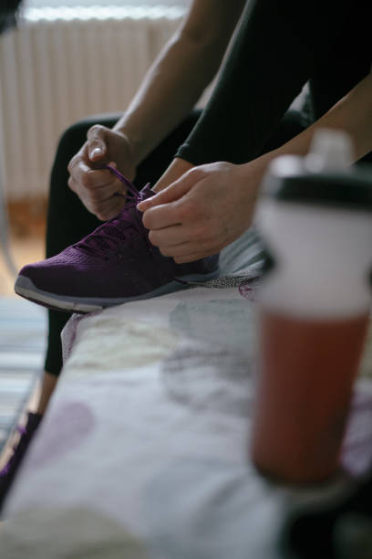 istock Woman tying laces preparing for training 1292624797
