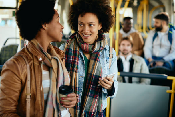 istock Happy African American female friends talking while commuting by bus. 1292625568