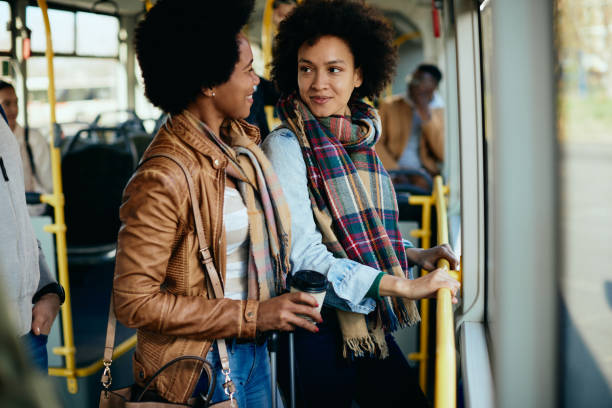 istock Happy black women talking while traveling by bus together. 1292625799