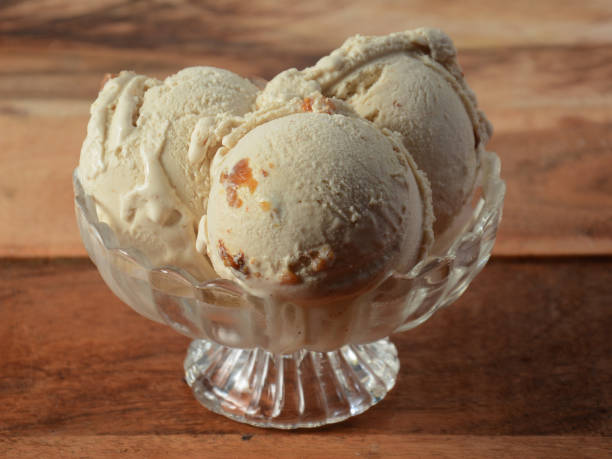 istock Honey fig ice cream scoops served in a glass bowl over a rustic wooden table, selective focus 1292626182