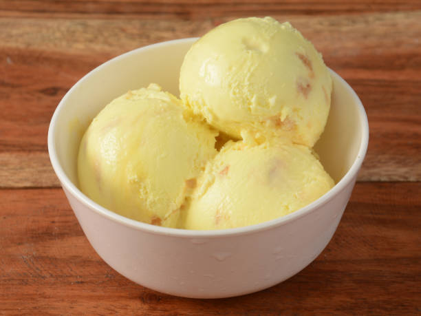 istock Butter scotch ice cream scoops served in a bowl over a rustic wooden table, selective focus 1292626767