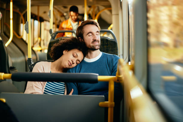 istock Smiling couple relaxing with eyes closed while commuting by bus. 1292626811