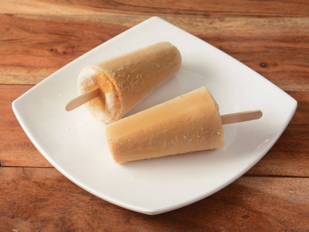 malai kulfi served in white plate over a rustic wooden background, selective focus malai kulfi served in white plate over a rustic wooden background, selective focus Malai Kulfi stock pictures, royalty-free photos & images