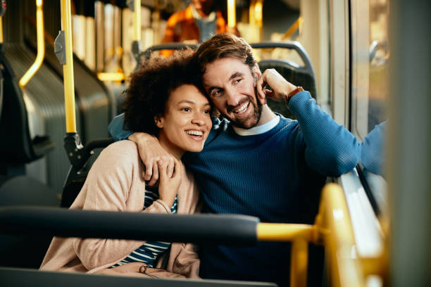 istock Embraced couple looking through the window while traveling by bus. 1292626862