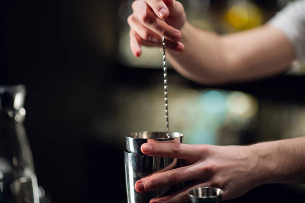 istock An experienced bartender prepares an alcoholic cocktail. No face, close-up, copy space 1292626895
