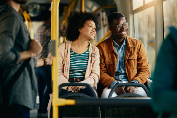 istock Happy black couple looking through the window while commuting by bus. 1292626911