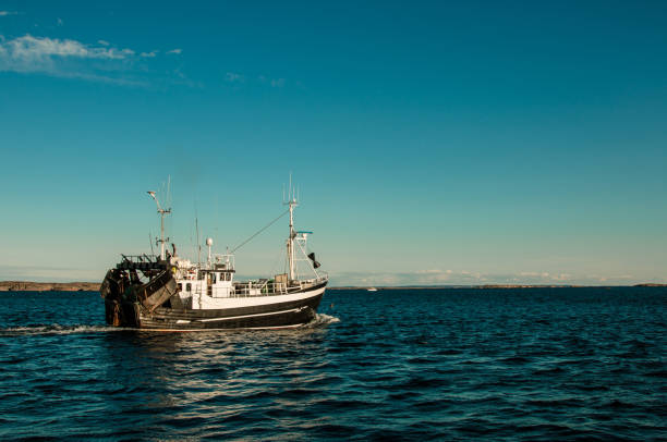 istock Fishing boat leaving harbour 1292627085