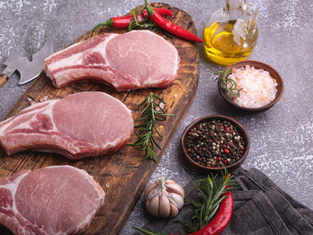 istock fresh raw meat pork, beef, chop on a bone, on the board, spices 1292627214