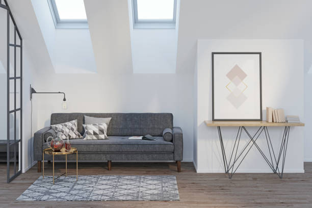 istock Modern attic with a vertical poster and books on a sideboard, a gray sofa with pillows, a coffee table with drinks, a glass partition, a carpet on a wooden floor, two skylights. Front view. 1292627440