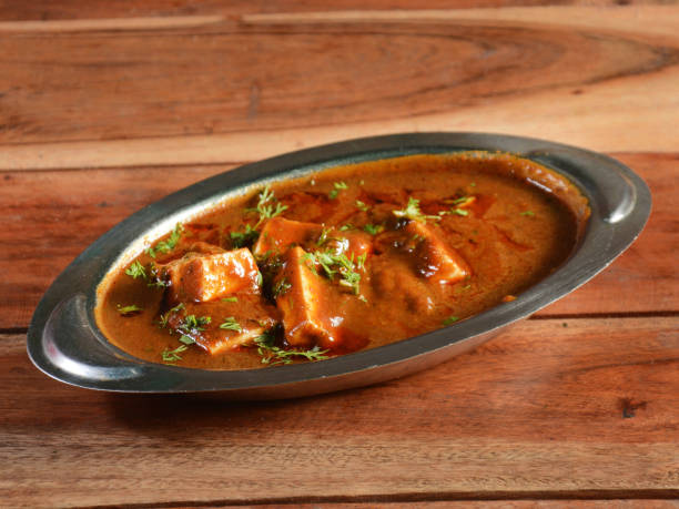 istock Paneer Masala, is a famous indian dish, served over a rustic wooden background, selective focus 1292628200