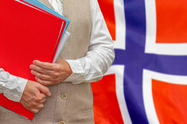 istock Woman's hands holding documents against Norway flag background. Education abroad 1292628637