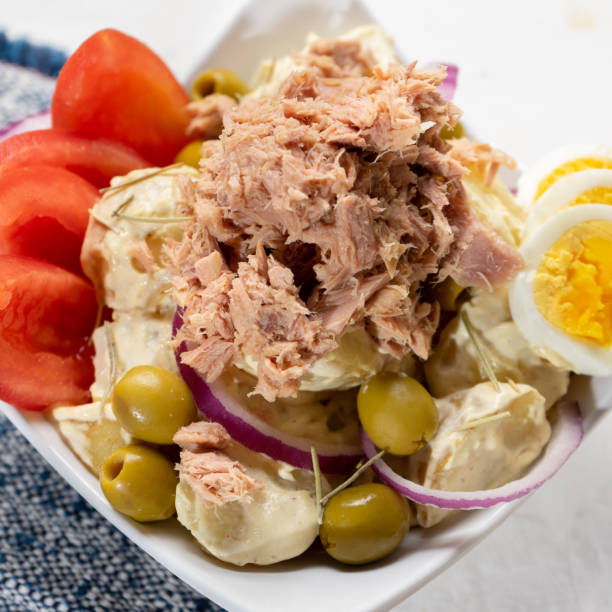 istock Tuna salad with potatoes and boiled egg called nicoise on white background 1292629703